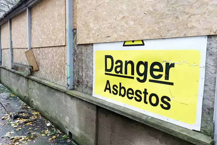 Danger Asbestos warning sign on a building exterior